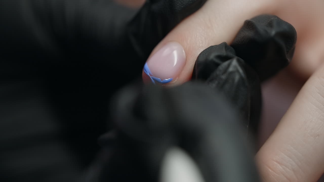 Woman getting a manicure with blue nail art