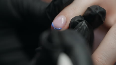 woman getting a manicure with blue nail art