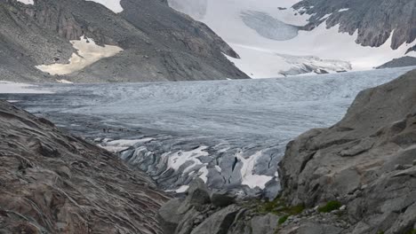 Rhone-blue-glacier-on-top-of-the-Alps-with-rocky-and-snowy-mountains-aside,-Switzerland,-Valais