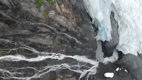 waterfall leading to icy glacier