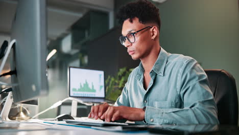 man working on computers in office