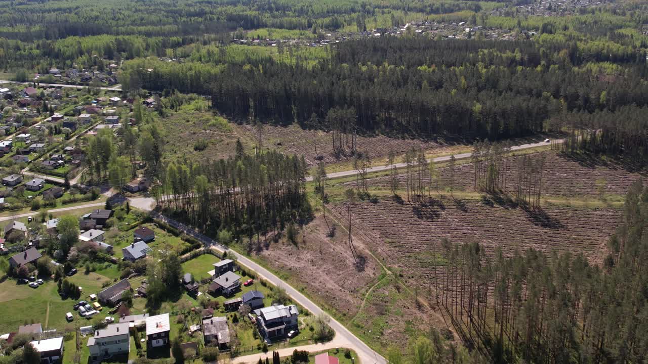 Aerial view of a suburban area with forest and cleared land