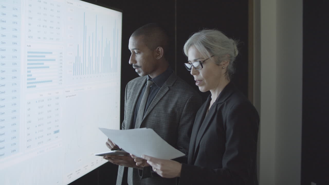 Professional investors analyzing stock market statistics