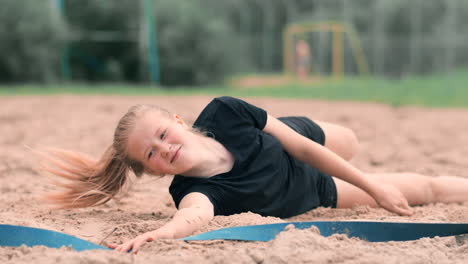 slow motion: a young woman jumping in the fall hits the ball on the sand. volleyball player makes a team and plays the ball off in the fall.