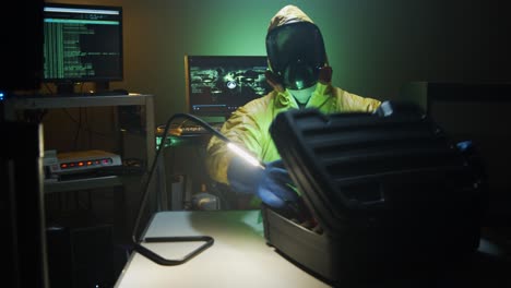 bioterrorist examines a bottle of dangerous liquid