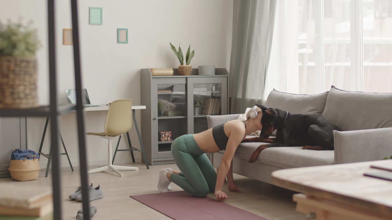 Sportswoman Kissing Her Doberman Dog