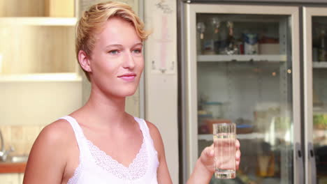 pregnant woman drinking glass of water