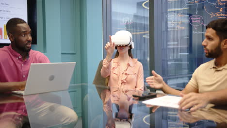 using vr headset, woman in meeting with multiracial colleagues discussing project in office