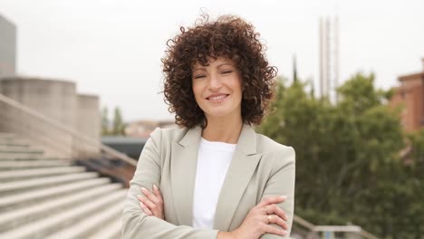 portrait of smiling female executive standing arms crossed