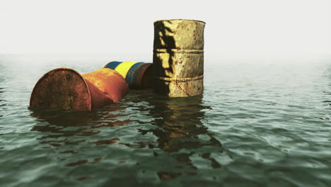 rusty barrels floating on calm water at sunset with reflections