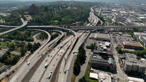 Drone shot of cars driving on Seattle&#039;s freeway system, heading out of the city
