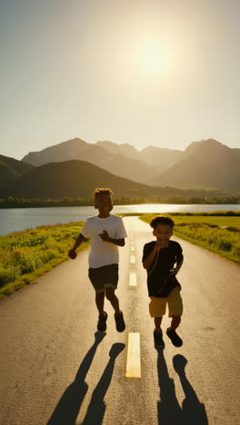 two young boys joyfully running on a scenic road at golden hour