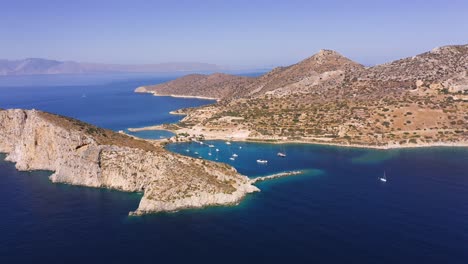 Flying-Near-Marine-Bay-On-Aegean-Sea-Situated-In-Hollow-Of-Hills,-Knidos,-Turkey