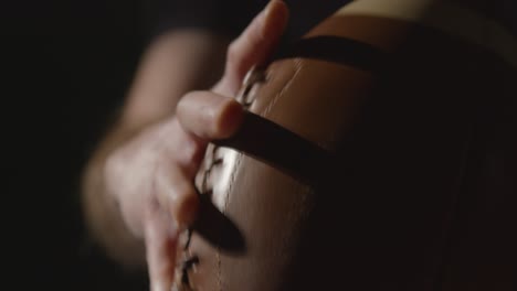 Close-Up-Studio-Shot-Of-American-Football-Player-Holding-Ball-With-Low-Key-Lighting-5