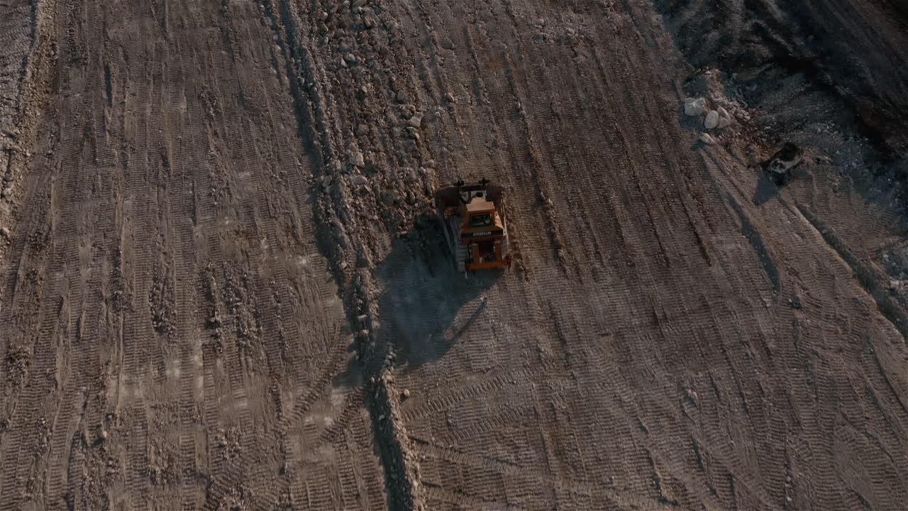 A multi terrain tractor compacts dirt. Clears the frame.