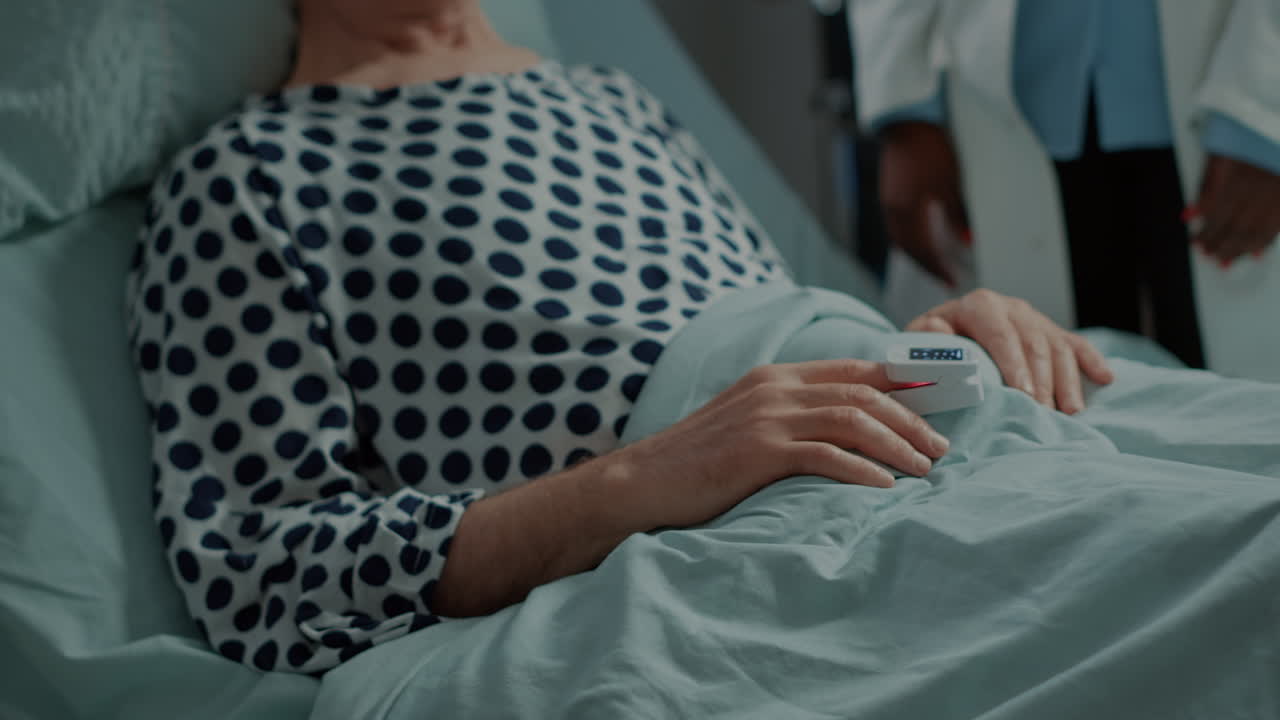 African american doctor connecting oximeter on patient
