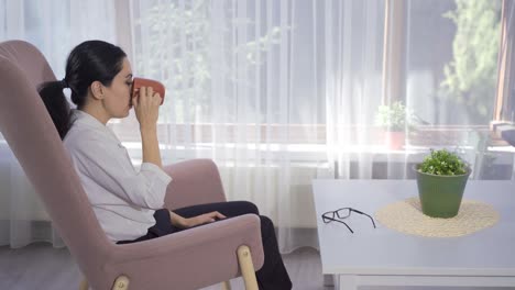 Woman-sitting-by-the-window.