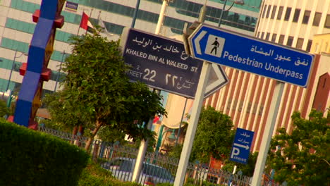 signs in english and arabic line a highway in the united arab emirates