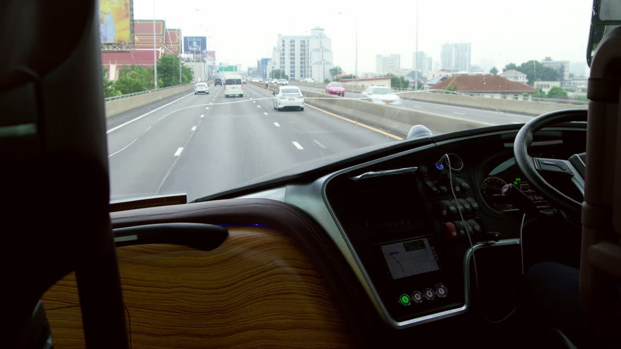 Bus driver expertly navigating the expressway during a city sightseeing tour. Transportation services for tourists with professional driving, offering smooth and safe travel on high-speed routes.