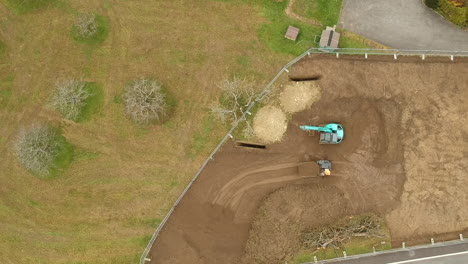 tractor moves soil removed from land