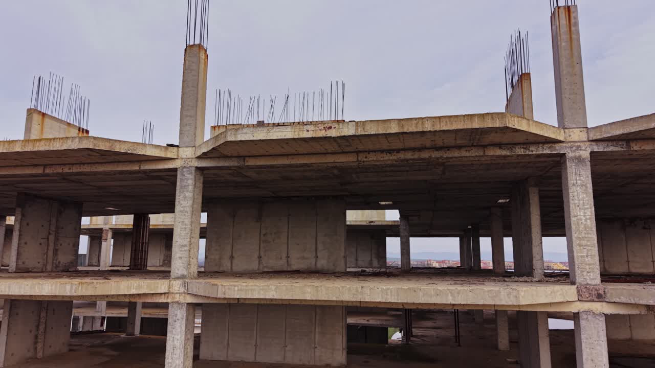 View of an unfinished concrete building from above showing empty floors