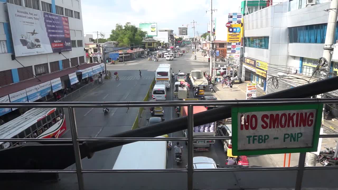 Stabilized cinematic shot from a bridge of vehicle traffic