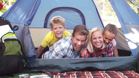 happy family on a camping trip in their tent