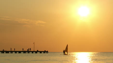 Man-windsurfing-at-sunset