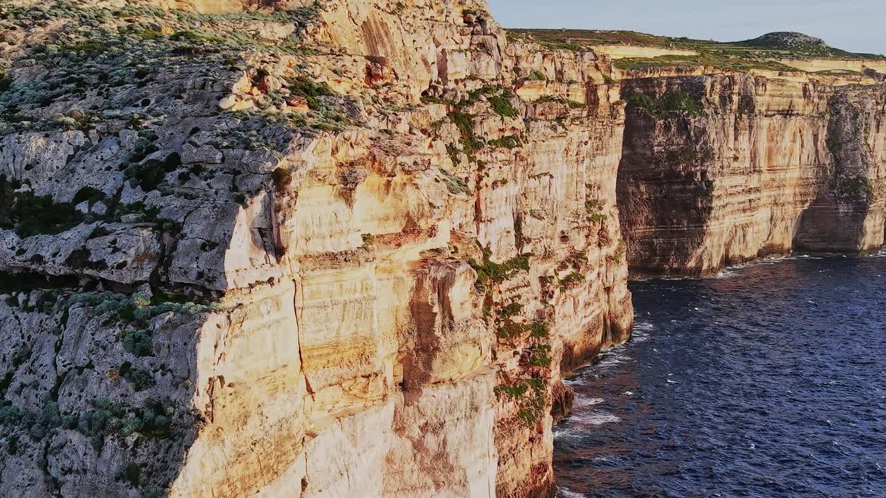 Explore Malta's cliffs and coastline near the water during sunset hours