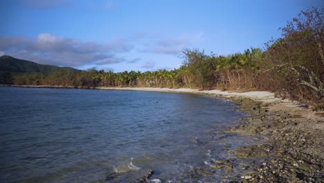 Ocean-Waves-Splashing-On-The-Rocky-Shore-In-Fiji-Island-On-A-Sunny-day---Gimbal-Shot