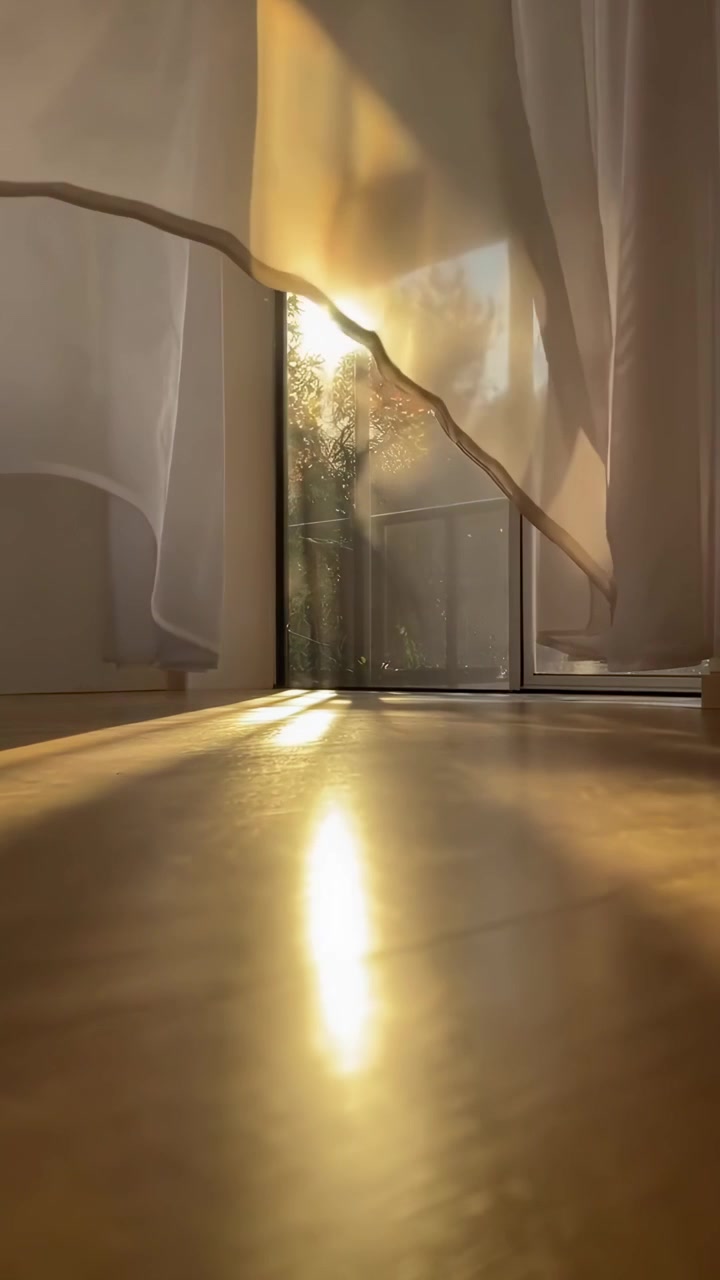 Golden Sunlight Streaming Through Sheer Curtains and Reflecting on Floor