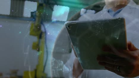 animation of rotating globe over caucasian man using tablet in computer laboratory