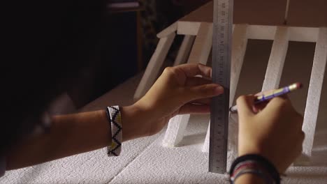 female student working as architect building housing model mock-up