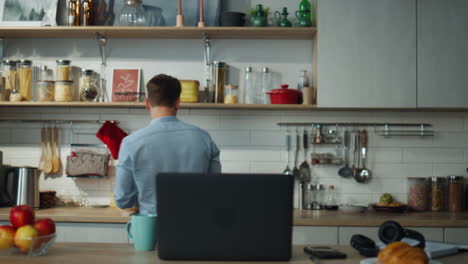 man cooking video lesson preparing breakfast at kitchen. guy using online recipe