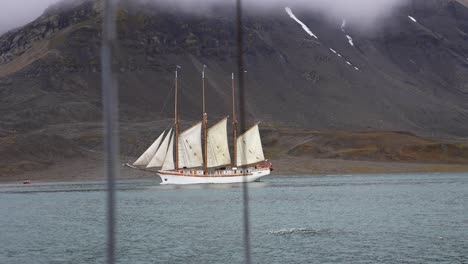 vintage ship with sails sailing in north sea water in norwegian fjord