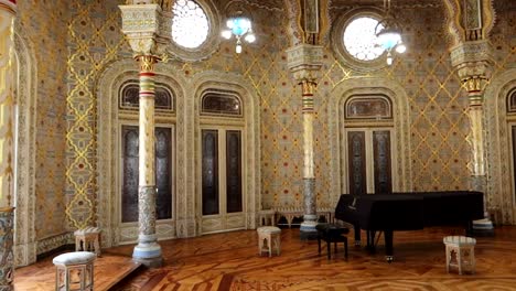 pan right shot of arabic room with furniture and grand piano, palacio da bolsa, porto