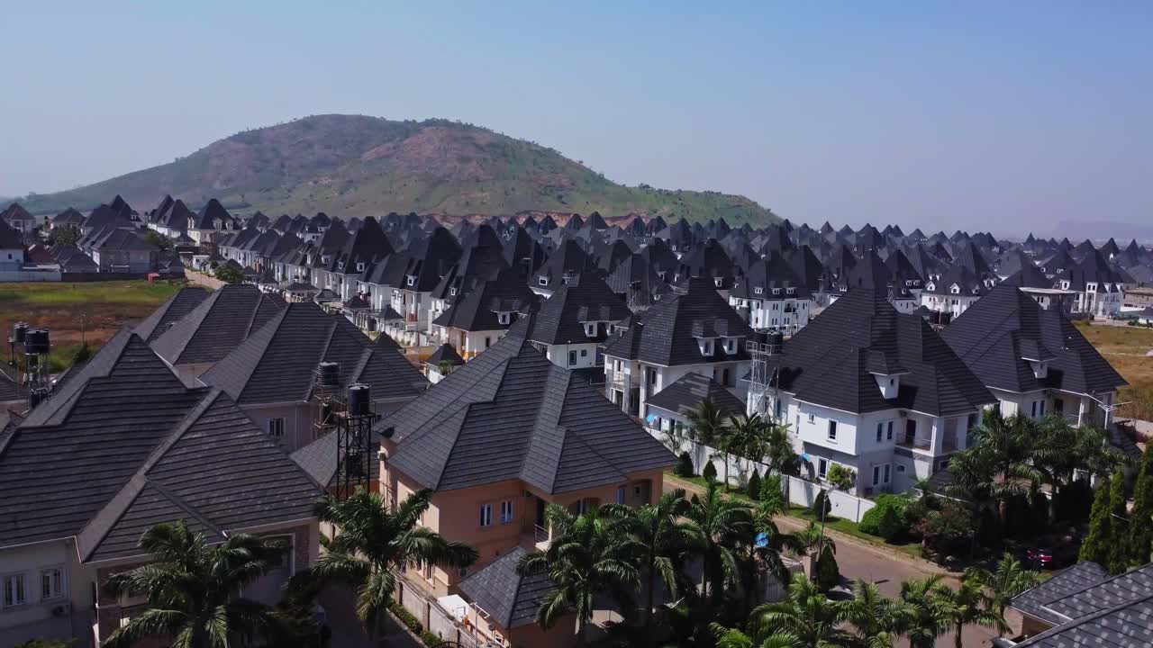 Máy bay không người lái bay thấp trên mái nhà và nghiêng xuống một ngôi nhà sang trọng mới xây trong khu dân cư ngoại ô giàu có ở Abuja, Nigeria.