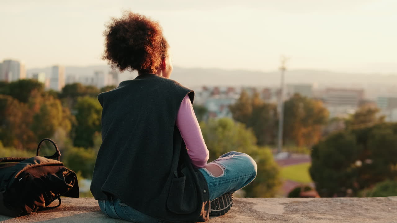 Girl Contemplates City View at Sunset