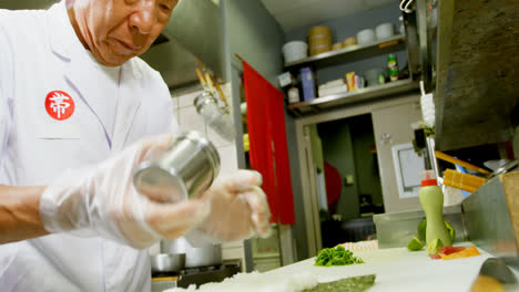 male chef preparing rice roll in kitchen 4k