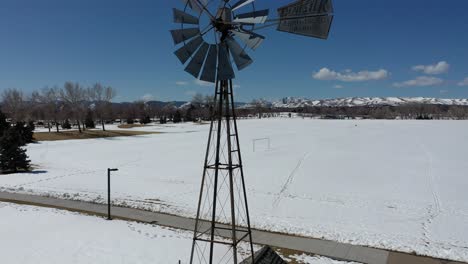 a rising drone shot by an old windmill