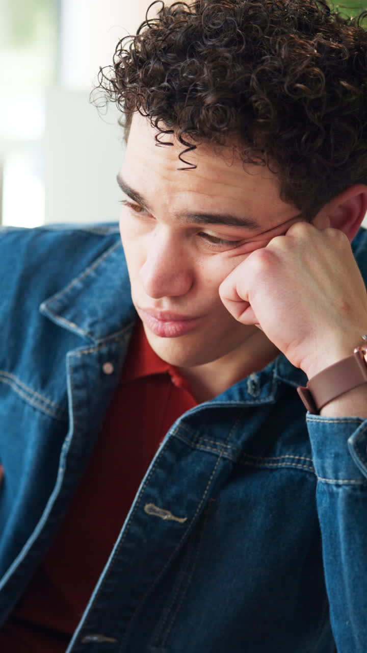 Thoughtful Young Man Resting His Head on His Hand