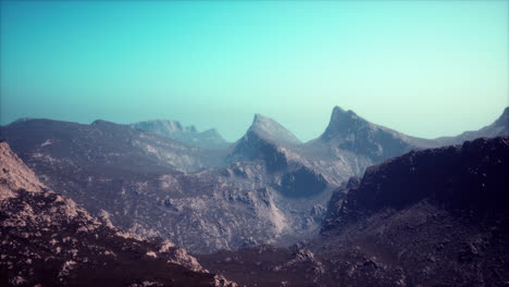 silhouette of swiss alps mountains in morning clouds