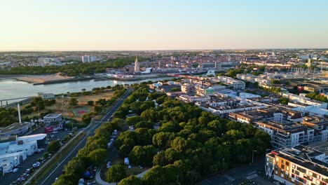 beautiful panorama drone view of la rochelle port area and modern buildings in a planned urban district at sunset, charente-maritime, france