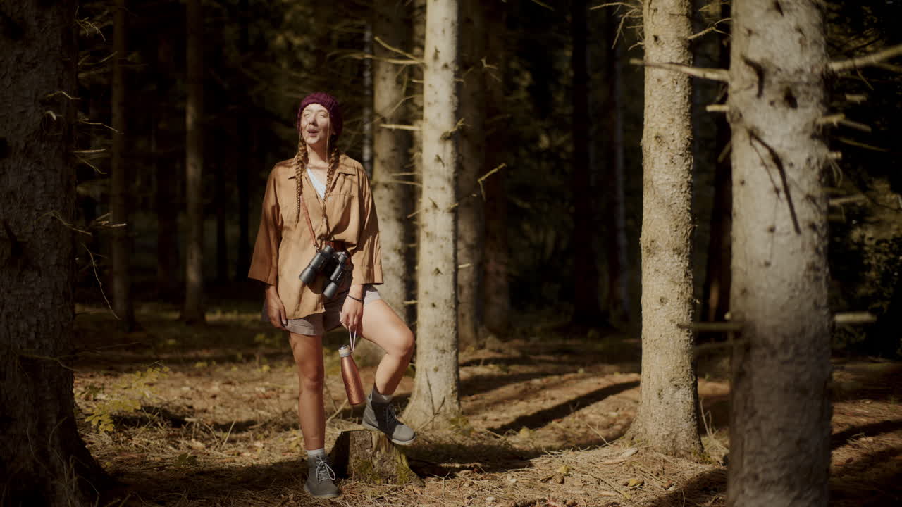 Woman enjoying sunlight on face in forest