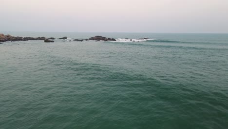 aerial drone shot of kanyakumari's coastline and urban charm set against the backdrop of a serene sunset.