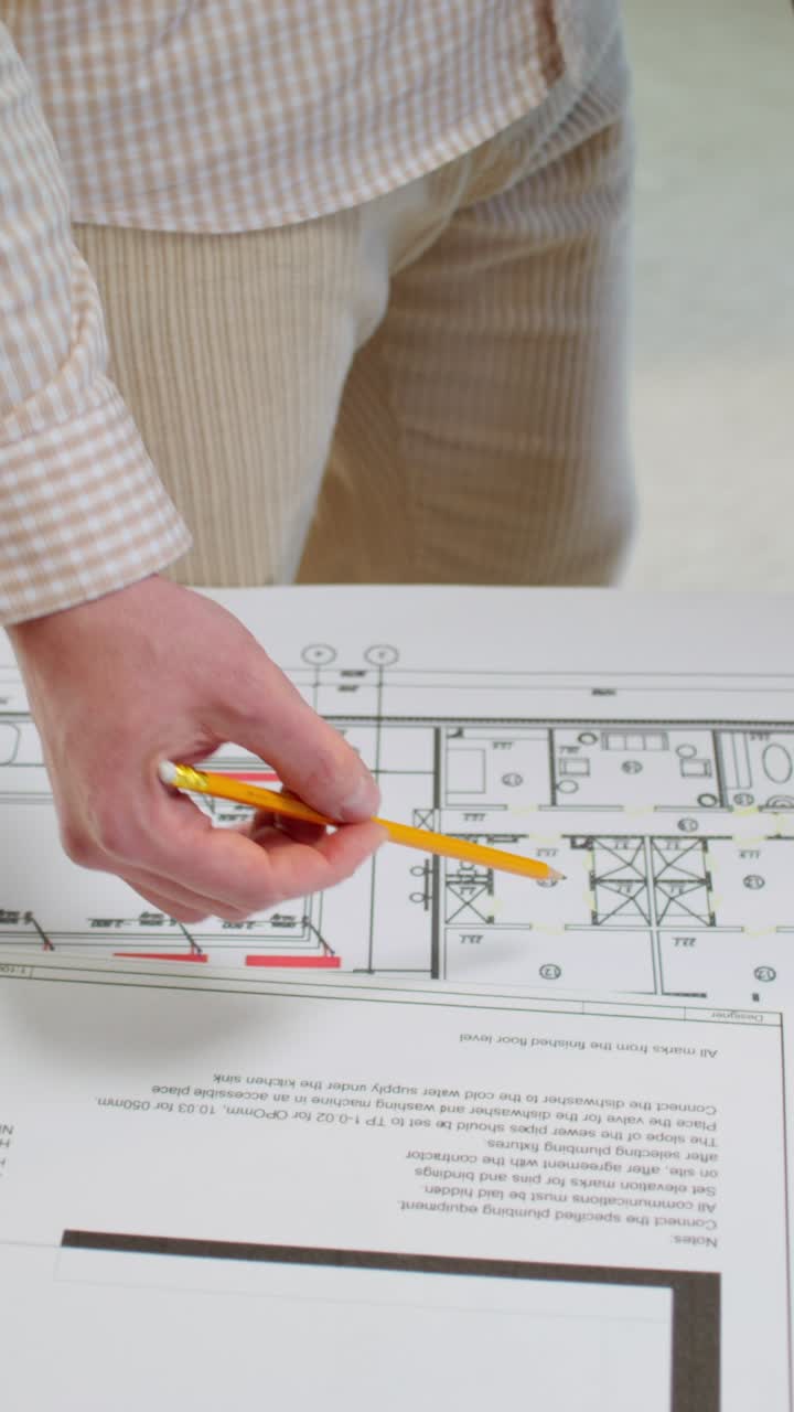 Person Reviewing Architectural Plans