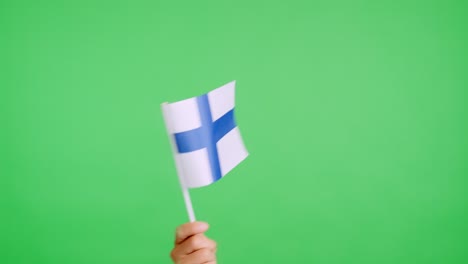 hand waving a pennant of a finnish national flag