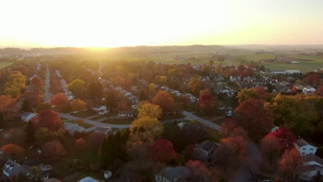 Establishing-shot-of-small-town-homes-set-among-rural-farm-fields-at-sunrise