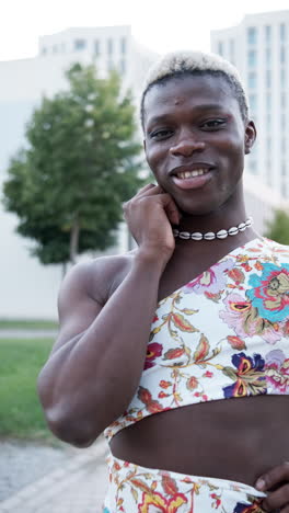 a person in floral clothing standing in front of a building
