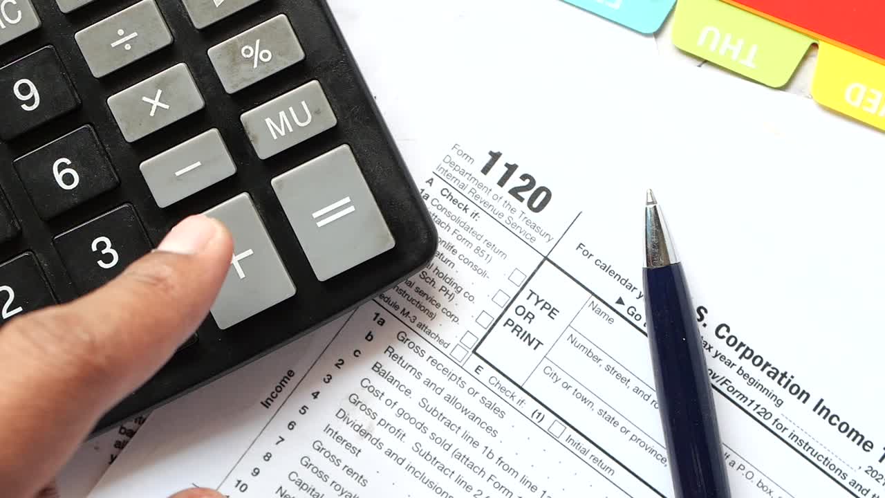 Preparing Corporate Taxes with Calculator and Tax Form 1120